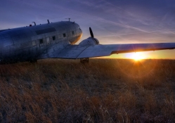 a DC_3 dakota on the prairie at sunset