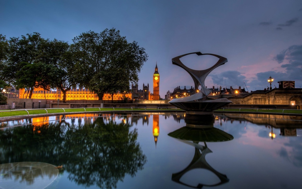 clock tower in london reflected in fountain