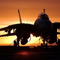 silhouette of F14 fighter on carrier at sunset