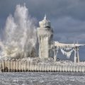 Wave Crashing On Lighthouse