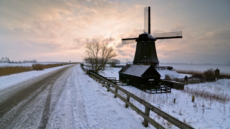 windmill by a winter country road