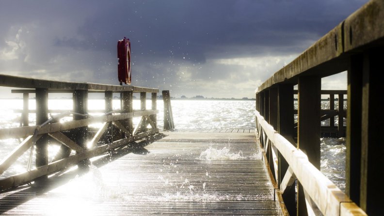 sea splashing through a wooden pier hdr