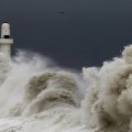 massive waves hitting a lighthouse