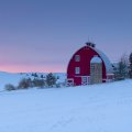 red barn and silo on a winter's sunset