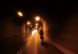 biker riding through a tunnel in taiwan