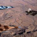 Two F_15 Eagles & F_22 Raptor over Desert