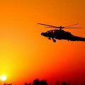 combat helicopter at sunset