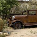 vintage rusted car in a desert town