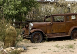vintage rusted car in a desert town
