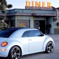 new vw beetle ragster in front of a diner
