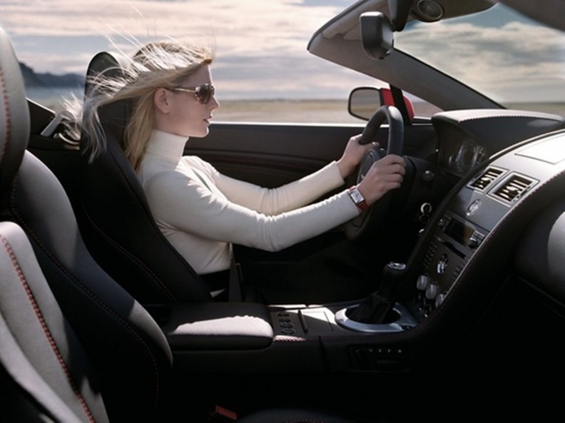 woman driving Aston Martin Vantage Roadster