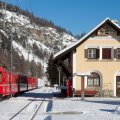 train in a station in la punt chamues in the swiss alps