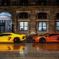 two lamborghinis parked in front of the ritz