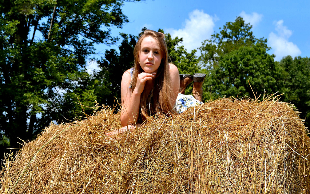 Cowgirl On A Hay Stack