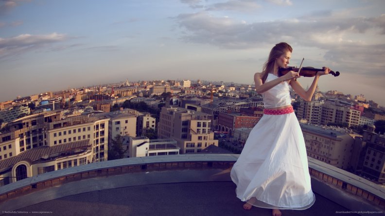 Playing Violin on a roof