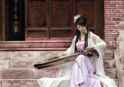 Asian girl playing a musical instrument