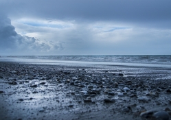 pebbles on a blue gray beach
